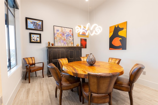 dining room with a chandelier and light hardwood / wood-style flooring