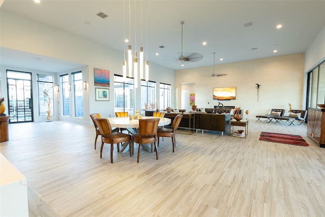 dining room with ceiling fan and light wood-type flooring