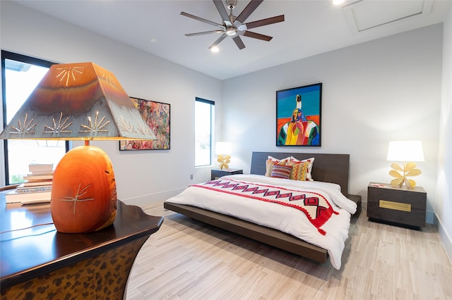 bedroom with ceiling fan and light wood-type flooring