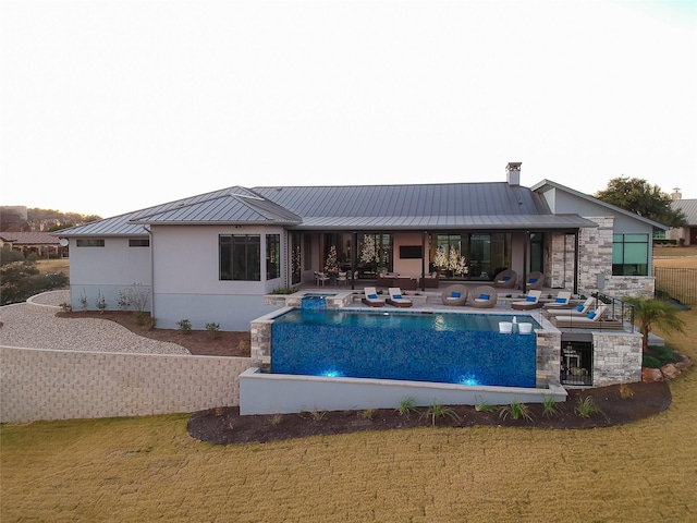 rear view of house with a patio area and a lawn