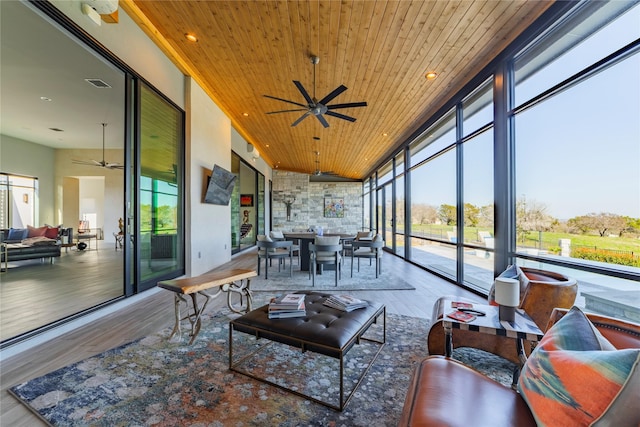 sunroom featuring wood ceiling and ceiling fan