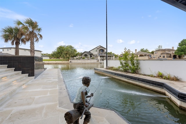 view of swimming pool featuring a water view