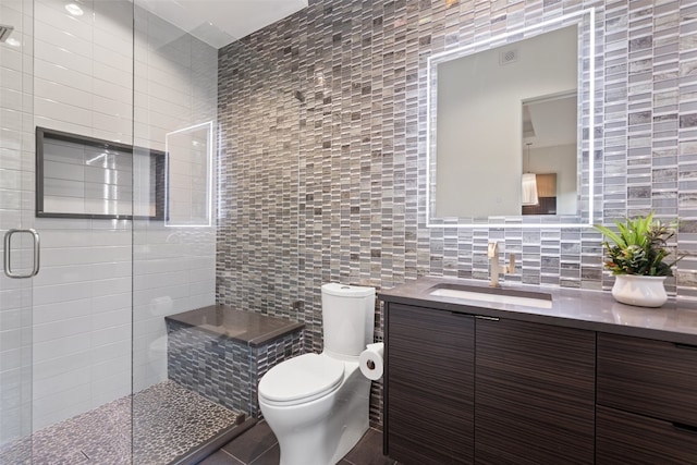 bathroom with tile walls, walk in shower, toilet, and tile floors