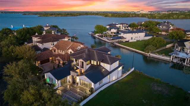 aerial view at dusk with a water view