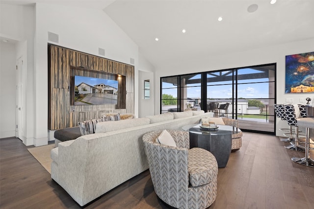 living room with high vaulted ceiling and dark wood-type flooring