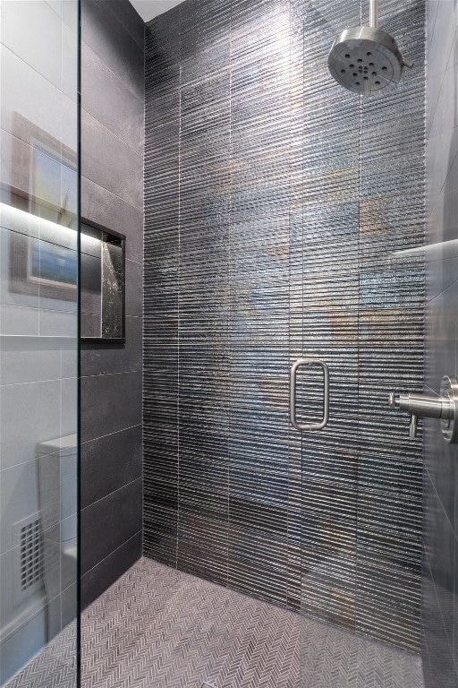 bathroom with a shower with door