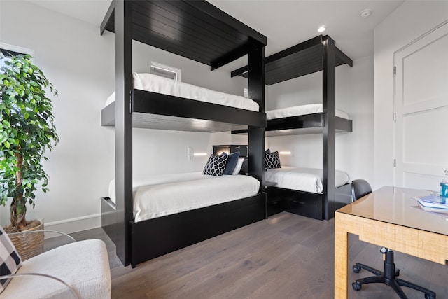 bedroom with dark hardwood / wood-style floors