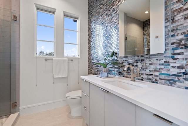 bathroom with tasteful backsplash, toilet, tile flooring, vanity, and walk in shower