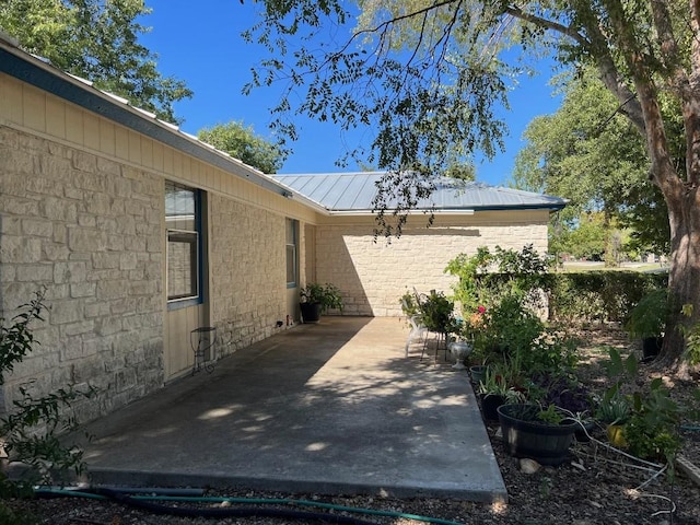 view of property exterior with a patio area