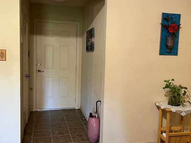 corridor featuring dark tile patterned flooring