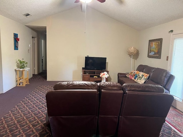 carpeted living room featuring ceiling fan, plenty of natural light, lofted ceiling, and a textured ceiling