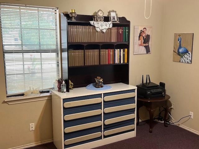 interior space with carpet flooring, multiple windows, and an inviting chandelier