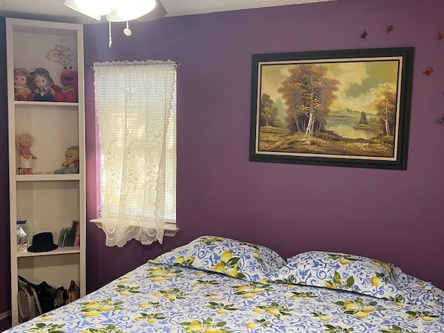 bedroom featuring a textured ceiling and ceiling fan