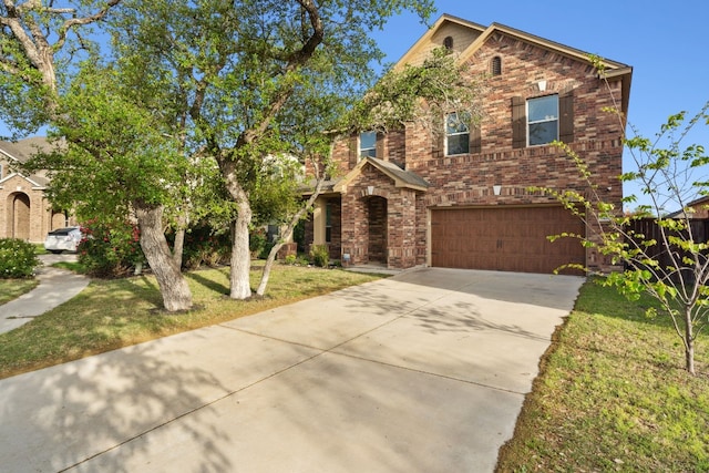 view of front of house with a garage and a front lawn