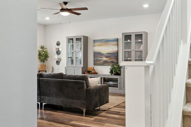 living room with ceiling fan and hardwood / wood-style flooring