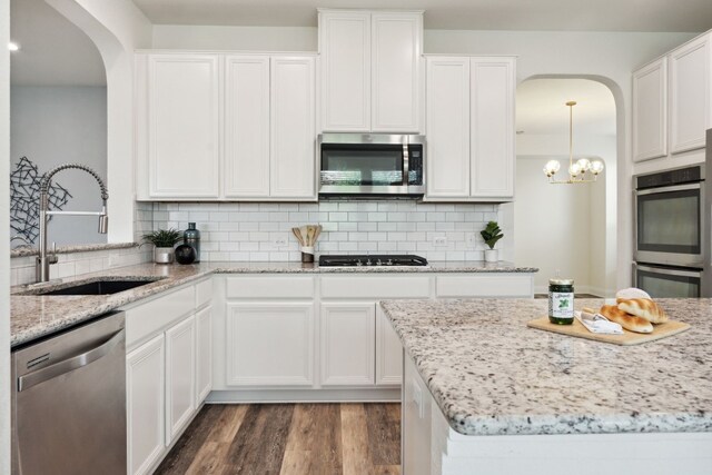 kitchen with white cabinets, stainless steel appliances, dark wood-type flooring, and sink