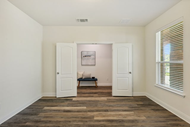 empty room featuring dark hardwood / wood-style flooring