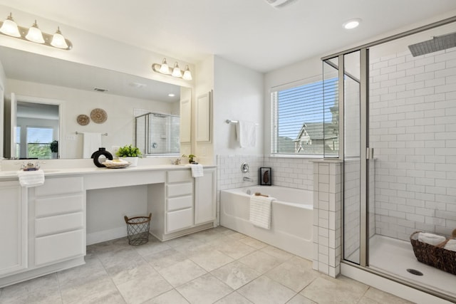 bathroom with tile patterned floors, vanity, and shower with separate bathtub