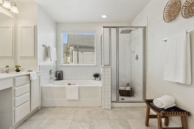 bathroom with plus walk in shower, vanity, and tile patterned flooring