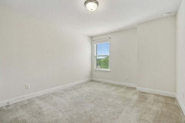 unfurnished room featuring light colored carpet