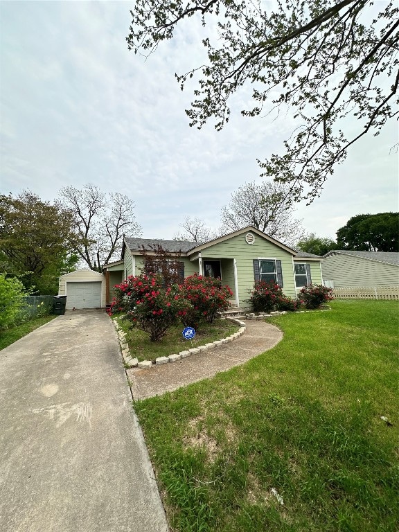 view of front facade with a front yard and a garage