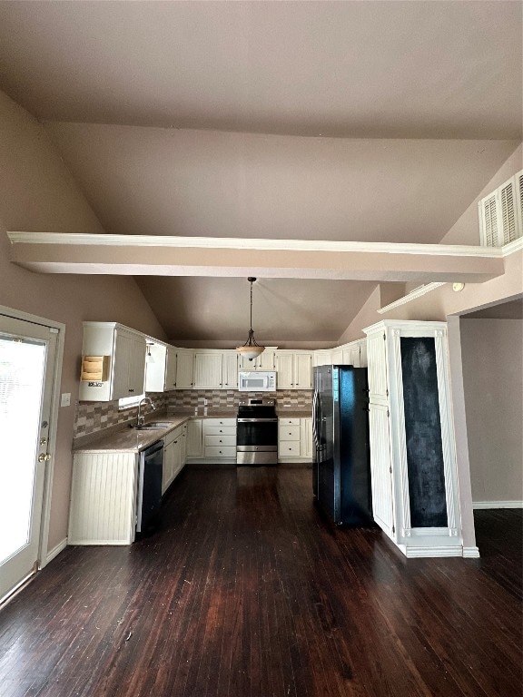 kitchen with black refrigerator, white cabinetry, hanging light fixtures, stainless steel stove, and dark hardwood / wood-style flooring