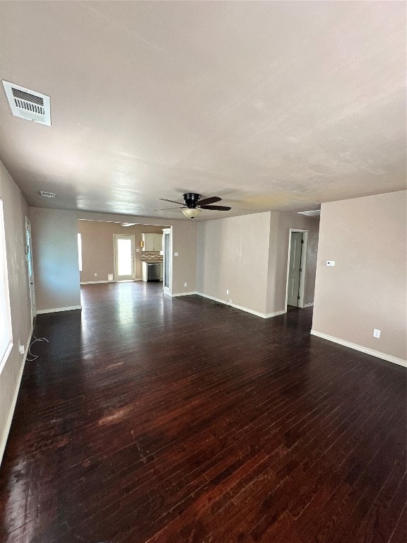 unfurnished living room with dark hardwood / wood-style flooring and ceiling fan