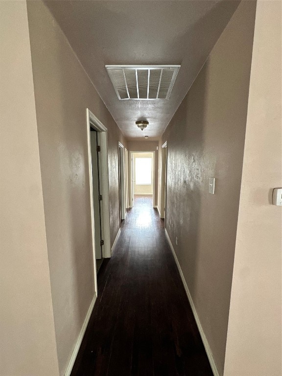 hallway with dark hardwood / wood-style floors