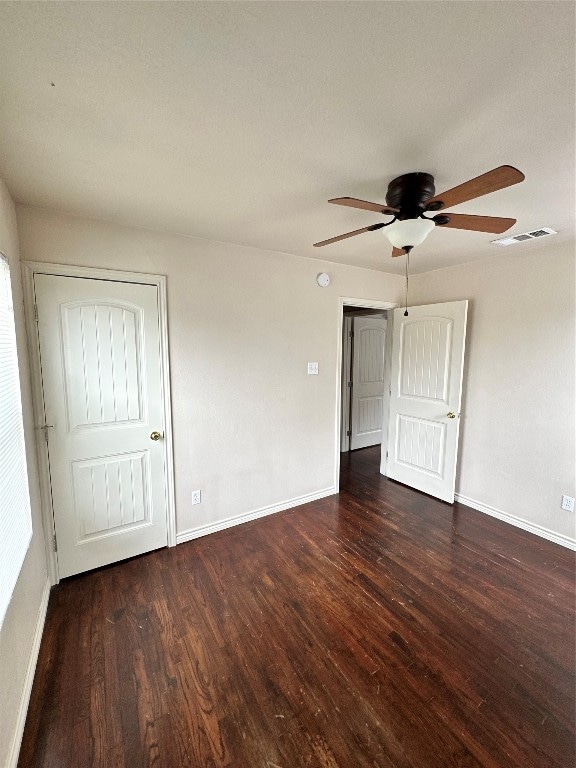 spare room featuring dark hardwood / wood-style floors and ceiling fan