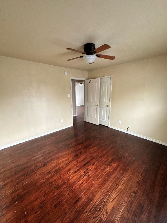 unfurnished room featuring dark hardwood / wood-style floors and ceiling fan