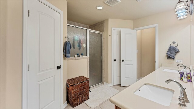 188 Zindler Ln, Paige, TX 78659 - bathroom featuring tile floors, an enclosed shower, and double vanity
