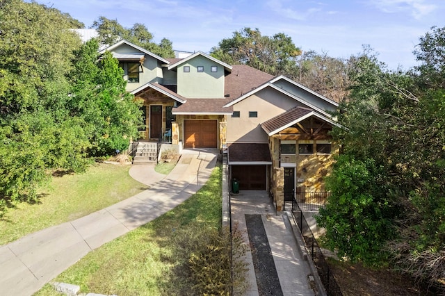 view of front of home with a garage and a front lawn