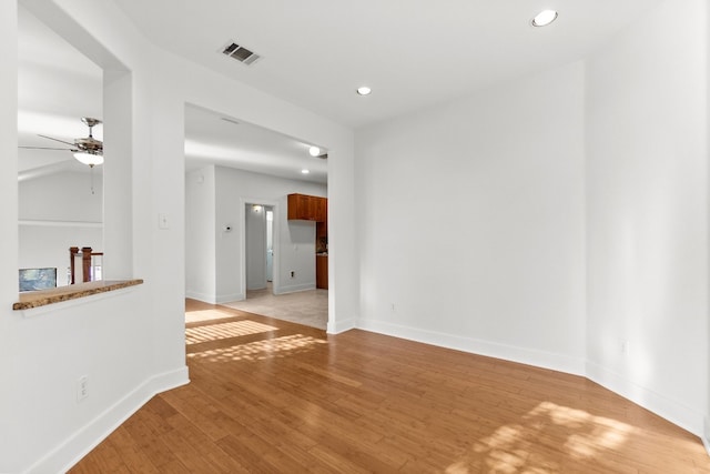 unfurnished room with baseboards, visible vents, a ceiling fan, light wood-style floors, and recessed lighting