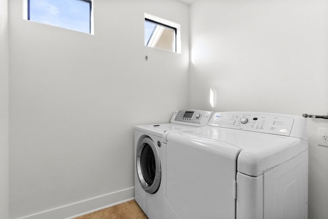 washroom featuring laundry area, independent washer and dryer, and baseboards