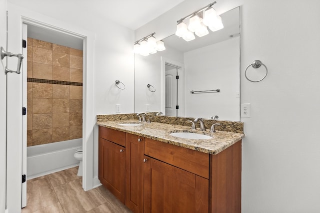 full bath with washtub / shower combination, a sink, toilet, and double vanity