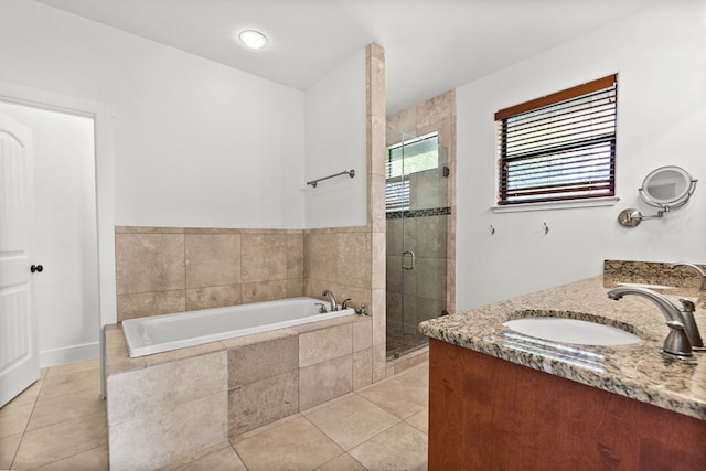 bathroom with a stall shower, tile patterned flooring, vanity, and a bath