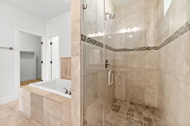 bathroom featuring a shower stall and a bath