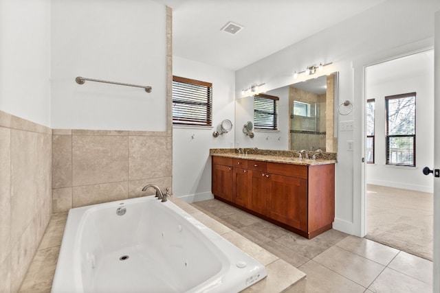 bathroom with a jetted tub, tile patterned floors, visible vents, and a healthy amount of sunlight