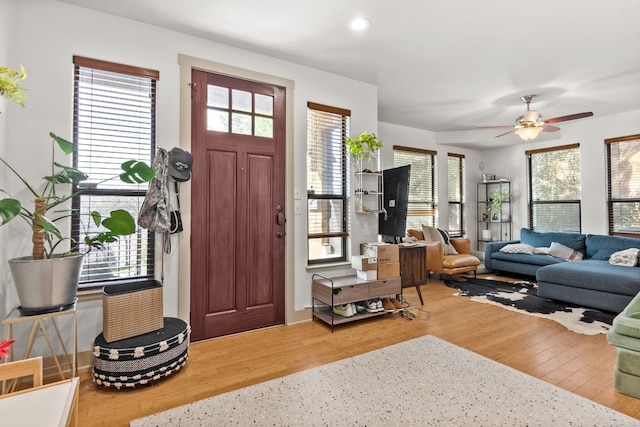 foyer featuring a wealth of natural light, a ceiling fan, wood finished floors, and recessed lighting