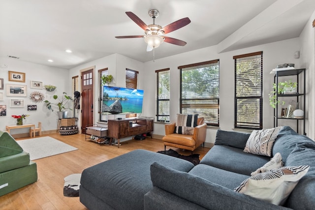 living room with recessed lighting, visible vents, light wood-style flooring, a ceiling fan, and baseboards