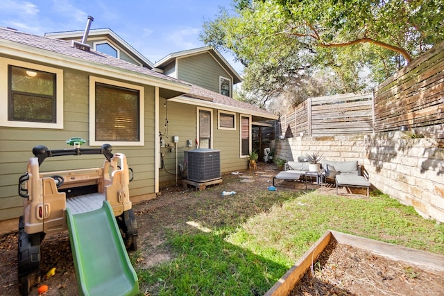 exterior space with central air condition unit and fence