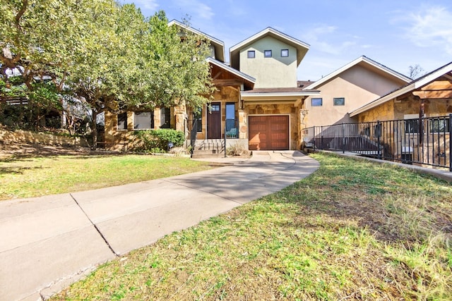 view of front of property with stone siding, a front yard, fence, and stucco siding