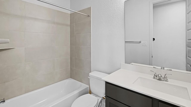 full bathroom featuring toilet, washtub / shower combination, and vanity