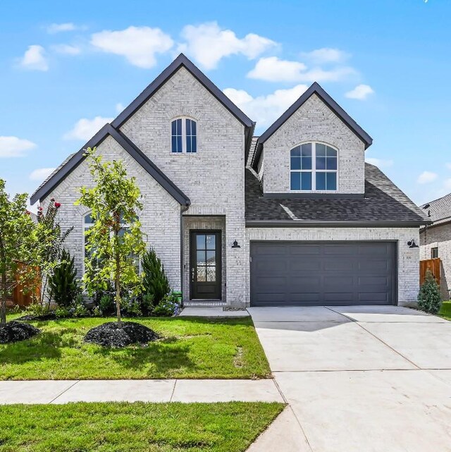 view of front facade with a garage and a front lawn