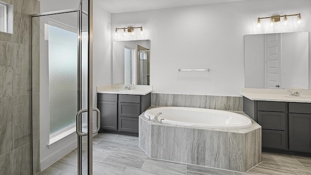 bathroom featuring a stall shower, plenty of natural light, and a garden tub