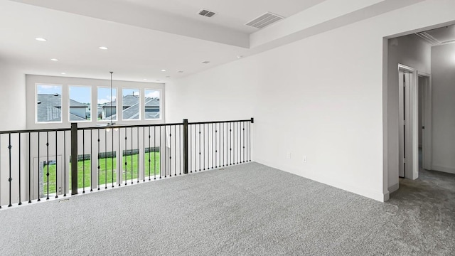 carpeted empty room featuring visible vents and recessed lighting