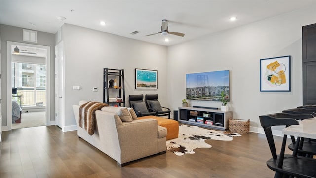 living room with dark hardwood / wood-style floors and ceiling fan