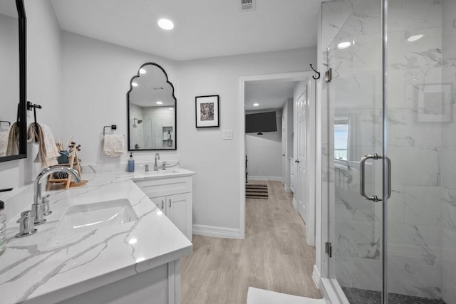 bathroom featuring an enclosed shower, hardwood / wood-style floors, and vanity