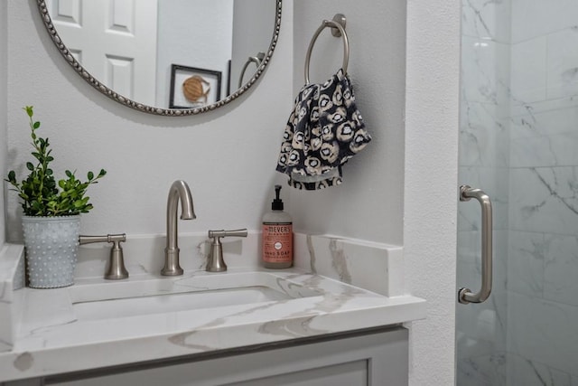 bathroom featuring vanity and a shower with shower door