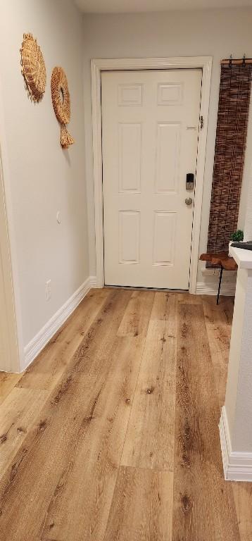 doorway with hardwood / wood-style flooring